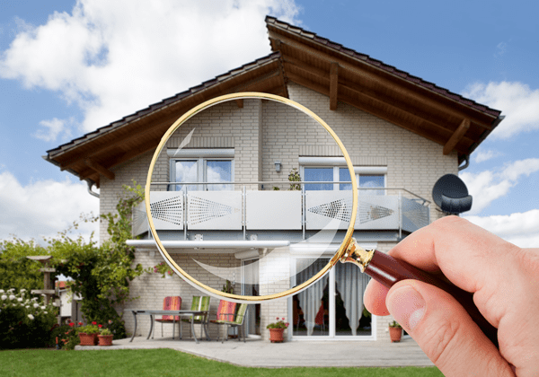 magnifying glass and exterior of home