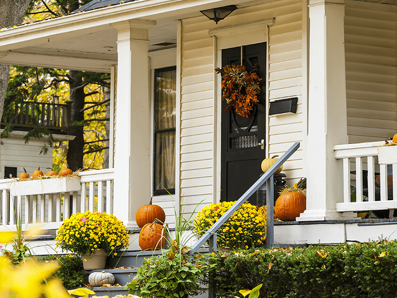 front view of beautiful home in fall with pumpkins