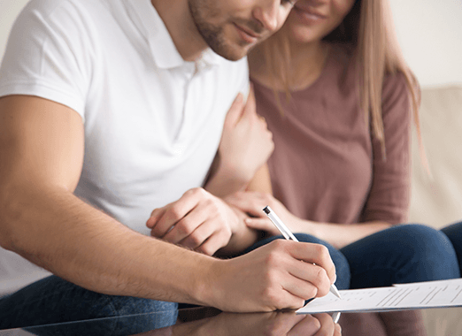 young couple signing house contract
