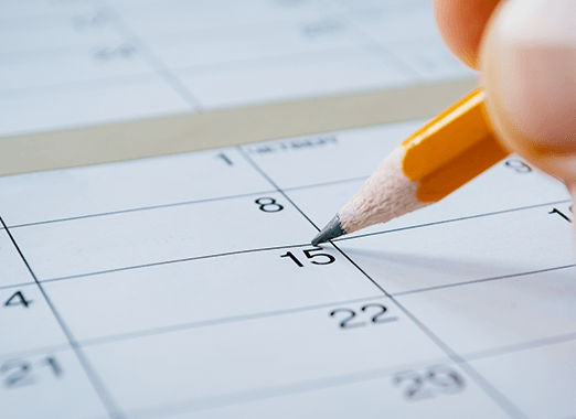 Pencil about to circle a date on a calendar